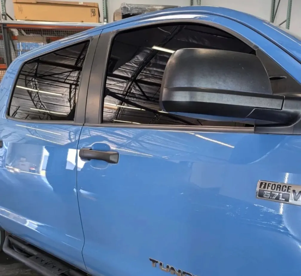 Blue truck with freshly ceramic tinted windows by Mirror ImagAZ